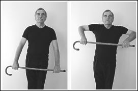 man exercising with walking stick - standing