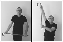 man exercising with walking stick - standing