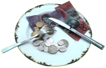 Money on a plate with knife and fork